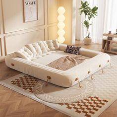 a large white couch sitting on top of a wooden floor