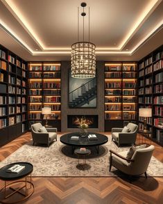 a living room filled with furniture and bookshelves next to a fire place under a chandelier