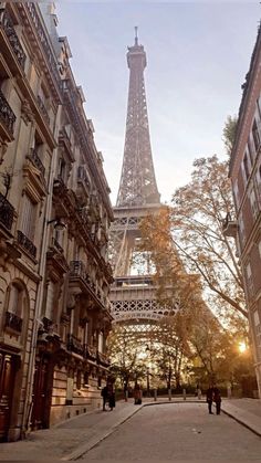 the eiffel tower in paris is seen from an alleyway between two buildings