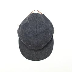 a gray hat sitting on top of a white table