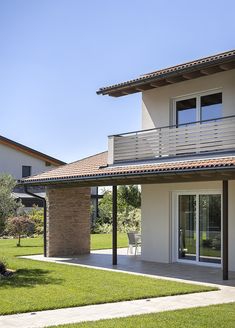 a modern house with an open patio and balcony