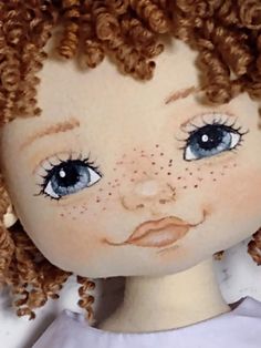 a doll with curly hair and blue eyes