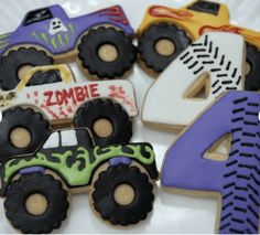 decorated cookies in the shape of cars and trucks on a plate with numbers 4 - 6