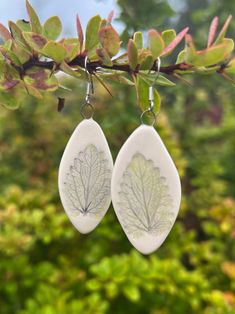 A pretty handmade earrings made of white clay and imprinted with leaves. Silver-filled hooks. Perfect drop earrings to match your daily and occasion wear. Lightweight and very comfortable. Size: 4.2 cm x 2cm / 1.7" x 0.7"  Made with love and care. The very nature of handcrafted ceramics guarantees that you are purchasing a unique work of art. Thank you for looking at my work! https://instagram.com/puucestudio Gift For Plant Lover, Earrings Ceramic, Botanical Earrings, Ceramic Earrings, Tree Earrings, Ceramic Earring, Earring Tree, Handcrafted Ceramics, Ceramic Jewelry