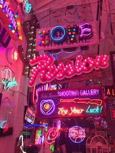 many neon signs are hanging from the ceiling