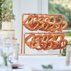 some pretzels sitting on top of a metal rack in front of a window