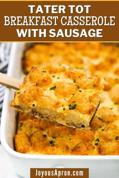 tater tot breakfast casserole with sausage in a white baking dish on a wooden spoon