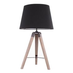 a wooden table lamp with a black shade on the top and wood legs around it