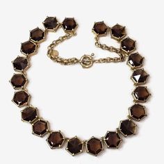 This is a Talbots hexagon shaped, faceted brown crystal necklace--a perfect blend of classic sophistication and contemporary charm. This necklace features a stunning array of 21 brown crystal set in a gold tone setting. The warm, earthy tones of the brown crystals add a touch of richness to any outfit, while the unique hexagonal shape and faceted finish catch the light for a subtle sparkle. Measures 21"l. and finished with a spring ring clasp. No damage or missing stones. Brown Crystals, Custom Jewellery, Jewellery Ideas, Crystal Set, Hexagon Shape, Earthy Tones, Spring Rings, Crystal Necklace, Custom Jewelry