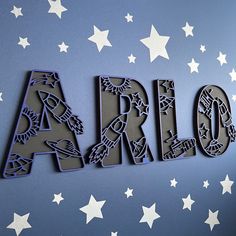 the word arlo spelled in cut out letters on a blue background with white stars