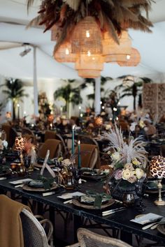 a dining room filled with lots of tables covered in plates and place settings for people to eat