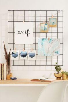 a white table with some pictures on it and a sign that says, creating a statement wall that comes down