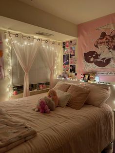 a bedroom decorated in pink and white with fairy lights on the wall above the bed