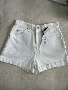 The perfect white vintage short. Vintage levis with a cuffed hem about 1 in cuff.  Slight discoloring because they are white and vintage, but hardly noticeable and may come out with a more aggressive detergent.  Measurements taken while flat 13.5 in waist (27 in) 20.5 in hip (41 in) 2.5 in inseam  12 in rise Vintage White Bottoms For Summer, Vintage White Summer Bottoms, Retro White Short Bottoms, White Casual Cutoff Jean Shorts, Casual White Cutoff Jean Shorts, White Relaxed Fit Retro Bottoms, Vintage White Jean Shorts, White High Waist Relaxed Fit Jean Shorts, Casual White Cutoff Shorts