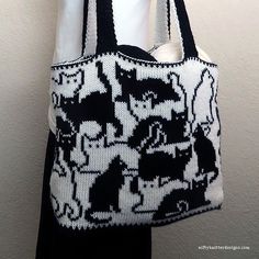 a black and white bag hanging on a wall