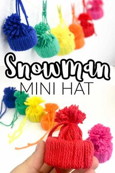 a hand holding a small knitted heart with the words snowman mini hat on it