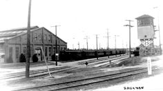 an old black and white photo of a train station