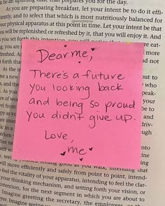 a piece of pink paper with writing on it next to a book page that says dear me there's a future you are going back and being so proud you didn't give up love