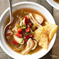 two bowls of soup with tortilla chips on the side