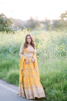 Aaradhya Lehenga can make the hidden elegance and glory come alive. This is a complete masterpiece of fancy lehenga, which has been very carefully designed using valuable mirror, pearl, stone, and embroidery work. This is completely perfect for reception and wedding wear; thus, it is an absolute must-have. Color: Sunshine Yellow Fabric and Work Style: Silk blouse with mirror, foil, sequin, and embroidery work Soft net lehenga with mirror, foil, and embroidery work Soft net dupatta with embroider Yellow Lehenga With Intricate Embroidery, Yellow Kundan Sharara With Intricate Embroidery, Yellow Bollywood Gown With Mirror Work, Yellow Dola Silk Lehenga With Dabka Work, Yellow Lehenga With Dabka Work In Traditional Drape, Yellow Saree With Dabka Work For Wedding, Yellow Dabka Work Saree For Wedding, Yellow Wedding Saree With Dabka Work, Bollywood Lehenga Embellished With Kundan For Navratri