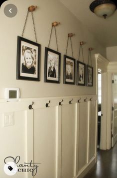 a hallway with pictures hanging on the wall