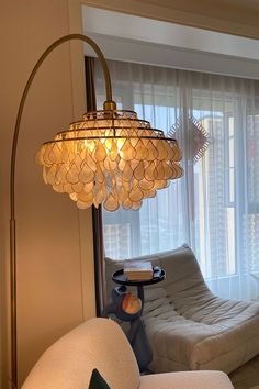 a living room filled with furniture and a chandelier hanging over the top of it