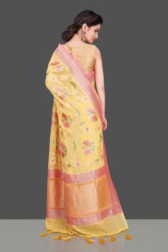 Stunning yellow georgette Banarasi saree is perfect for daytime weddings and festive occasions! The saree is adorned with pink zari border and pallu and has overall floral zari jaal enhanced with brush dyeing. It comes with a matching blouse piece. Buy online from Pure elegance. Disclaimer: The shown stitched blouse on the model is for display purpose only. The saree comes with a matching blouse piece and finished with fall and piko. Disclaimer: The actual product may vary slightly from the imag Georgette Banarasi Saree, Muga Silk, Banarasi Sari, Daytime Wedding, Fashion Journals, Indian Sari, Banarasi Saree, Traditional Fabric, Banarasi Sarees