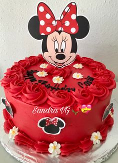 a minnie mouse birthday cake with red frosting