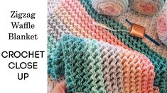 the crochet close up is shown with two balls of yarn and one ball of yarn