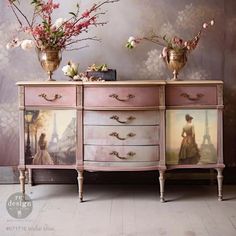 two vases with flowers on top of an antique dresser in front of a wallpapered background