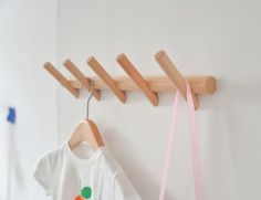 clothes hangers and t - shirts hanging on the wall in a children's room