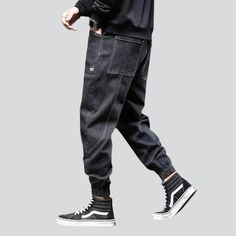 Take your fashion game to the next level with our 2023 Autumn Collection's street dark men's denim joggers! These monochrome. mid-waist joggers are perfect for making a statement. yet still keeping it comfortable and stylish. With their drawstring closure and stretchy fabric. they promise to keep you looking sharp even during the most intense streetwear looks.Why You'll Fall In Love Street Style: Make an impact with these joggers. designed to keep you looking your best no matter the season or oc Urban Streetwear Joggers, Urban Baggy Joggers For Streetwear, Urban Tapered Leg Joggers For Streetwear, Sporty Baggy Cargo Jeans For Streetwear, Hip Hop Style Relaxed Fit Joggers For Streetwear, Relaxed Fit Hip Hop Joggers For Streetwear, Tapered Leg Denim Blue Cargo Jeans For Streetwear, Denim Tapered Leg Cargo Pants For Streetwear, Denim Blue Tapered Leg Cargo Jeans For Streetwear