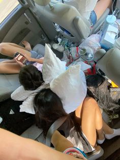 several mannequins are sitting in the back of a car with their heads wrapped up