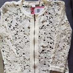 a white jacket with lacy lace on it