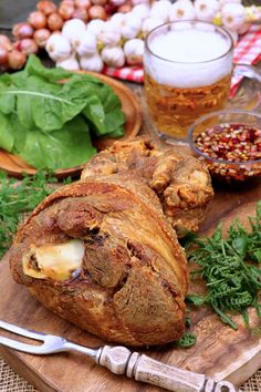 a wooden cutting board topped with meat and veggies