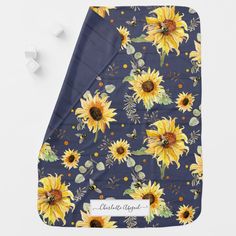 a blue blanket with yellow sunflowers on it