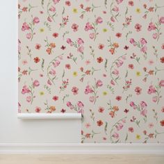 an empty room with flowers painted on the wall and wooden flooring next to it