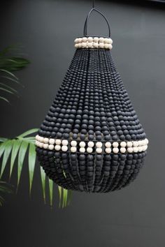 a black and white beaded chandelier hanging from a ceiling