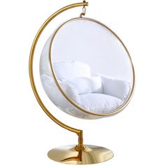 a white and gold hanging chair in the shape of an egg with pillows on it