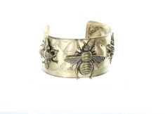 "Honey Bee or Mason Bee Hammered Cuff Bracelet, 1.5\" wide, antique gold, Made in USA, Each" Antique Gold Cuff Bracelet Bangle, Gold Cuff Bracelet With Antique Finish, Antique Gold Metal Cuff Bracelet For Gift, Antique Gold Metal Cuff Bracelet As Gift, Vintage Gold Cuff Bracelet With Antique Finish, Gold Antique Finish Cuff Bracelet, Gold Antique Finish Cuff Bangle, Gold Cuff Bracelet With Antique Finish As Gift, Gold Antique Finish Bangle Cuff Bracelet