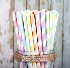 colorful striped paper straws in a mason jar