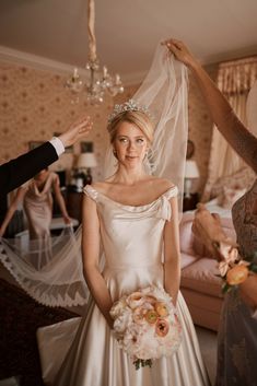 the bride is getting ready to walk down the aisle with her veil over her head