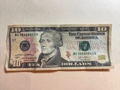 a ten dollar bill with the portrait of george washington on it's back side