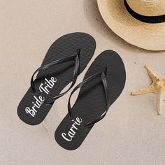 two pairs of flip flops sitting next to a straw hat and starfish