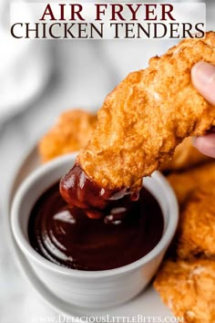 a person dipping sauce on chicken tenders in a small white bowl with text overlay that reads air fryer chicken tenders