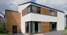 an image of a modern house with wood sidings on the outside and windows in the inside