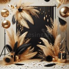 golden and black decorations are on display in front of a backdrop that is decorated with feathers