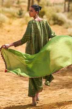 Kachha aam kaftan style tunic with bandhani print and resham and coin embroidery. Paired with a pant and dupatta.
Components: 3
Pattern: Embroidered, Printed
Type Of Work: Resham, Coin
Neckline: V Neck
Sleeve Type: Three-quarter
Fabric: Satin Silk
Color: Green
Occasion: Mehendi and Haldi - Aza Fashions Festive Traditional Pattern Maxi Kaftan, Festive Traditional Maxi Kaftan, Festive Traditional Pattern Maxi Length Kaftan, Festive Maxi Length Kaftan With Traditional Patterns, Bohemian Long Sleeve Anarkali Set For Summer, Festive Maxi-length Kaftan With Traditional Patterns, Summer Bohemian Long Sleeve Anarkali Set, Traditional Drape Kaftan With Patterns, Festive Anarkali Kaftan With Traditional Patterns