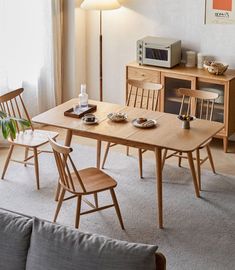 a wooden table and chairs in a room