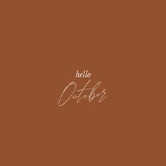 the words hello october written in cursive writing on a brown background with white ink